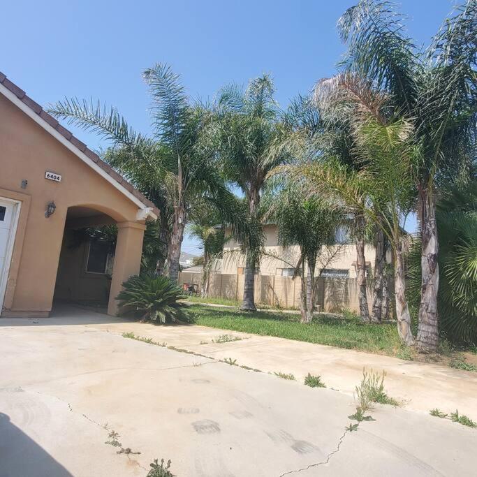 a house with palm trees in front of a driveway at Amazing palm villa house in Riverside