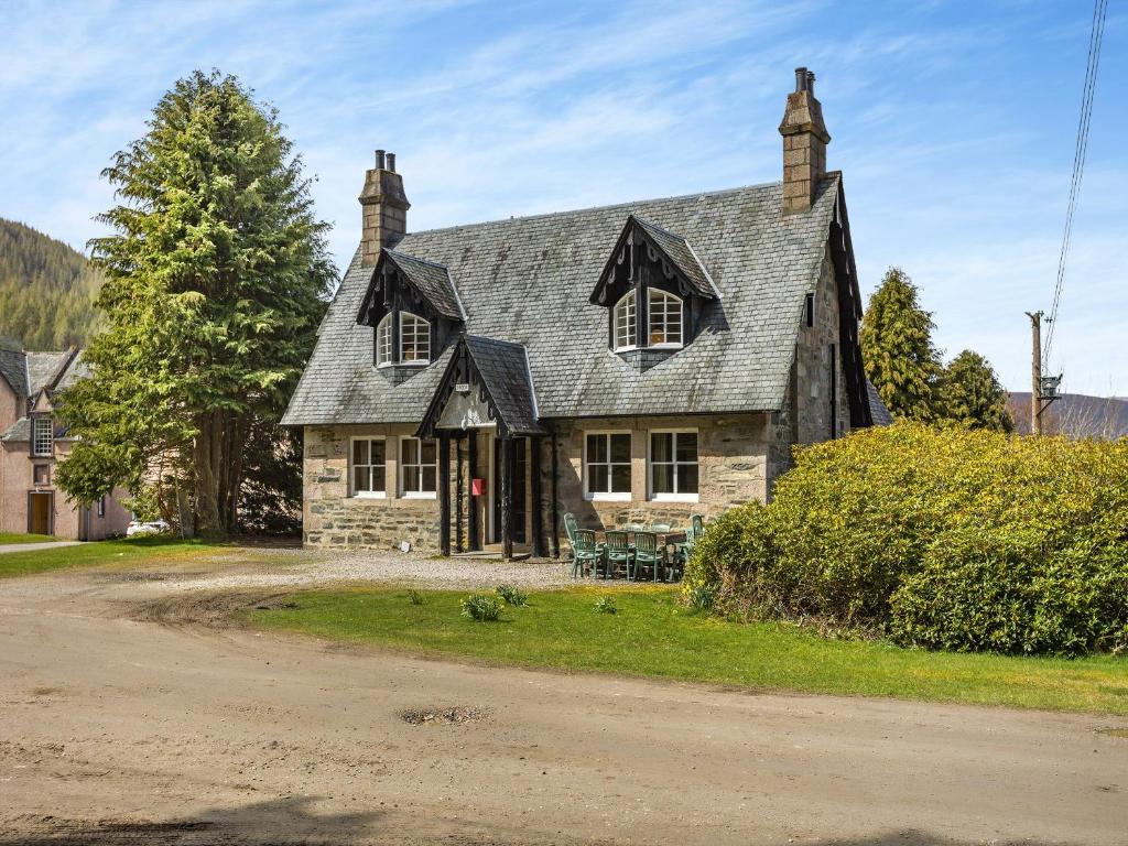 an old stone house on a dirt road at The Knock in Inverey