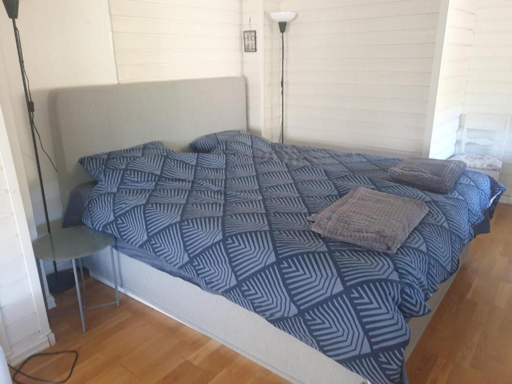 a bed with a blue and white comforter in a room at Holiday Home in Gol