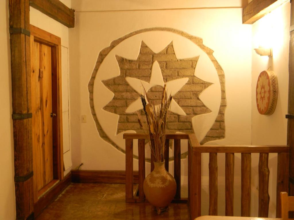 a vase sitting on a table in a room at La Troje de Adobe in Creel