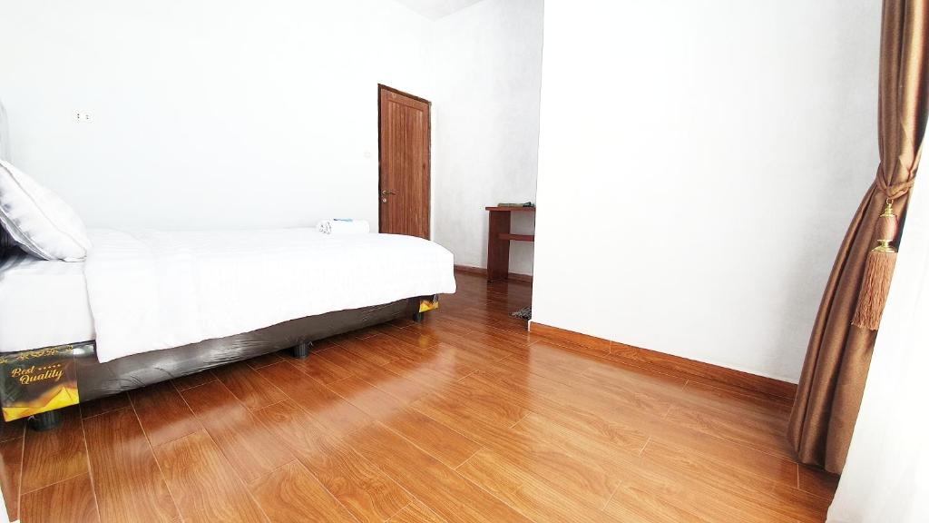 Postel nebo postele na pokoji v ubytování Depik Inn