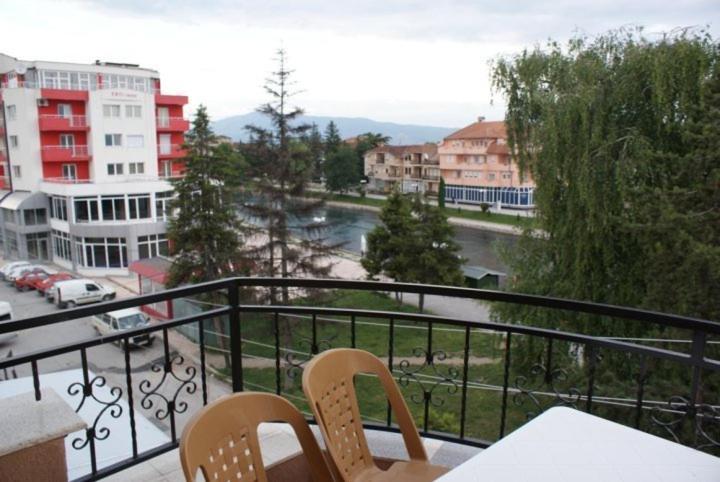 a balcony with two chairs and a view of a city at Jovanoski Apartments in Struga