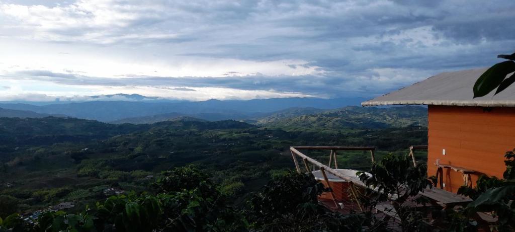 a view of the mountains from a house at Glamping Orosierra in Chinchiná