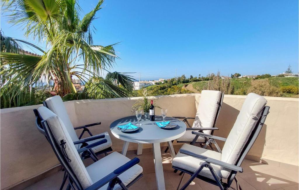 a patio with a table and chairs on a balcony at Cozy Apartment In Mijas With Swimming Pool in Mijas