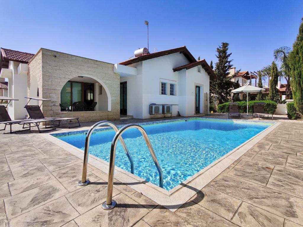 a swimming pool in front of a house at Ayia Napa Villa with private pool in Ayia Napa
