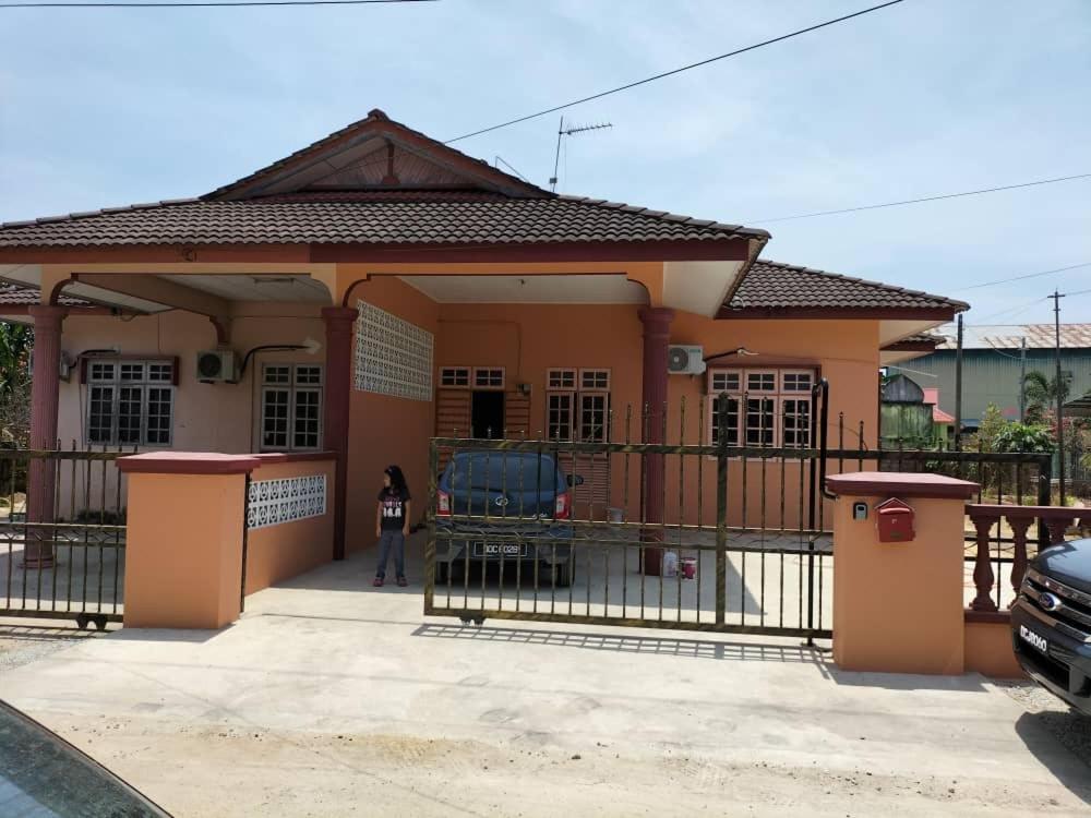 a small house with a gate in front of it at EZ Homes Lundang Kota Bharu in Kota Bharu