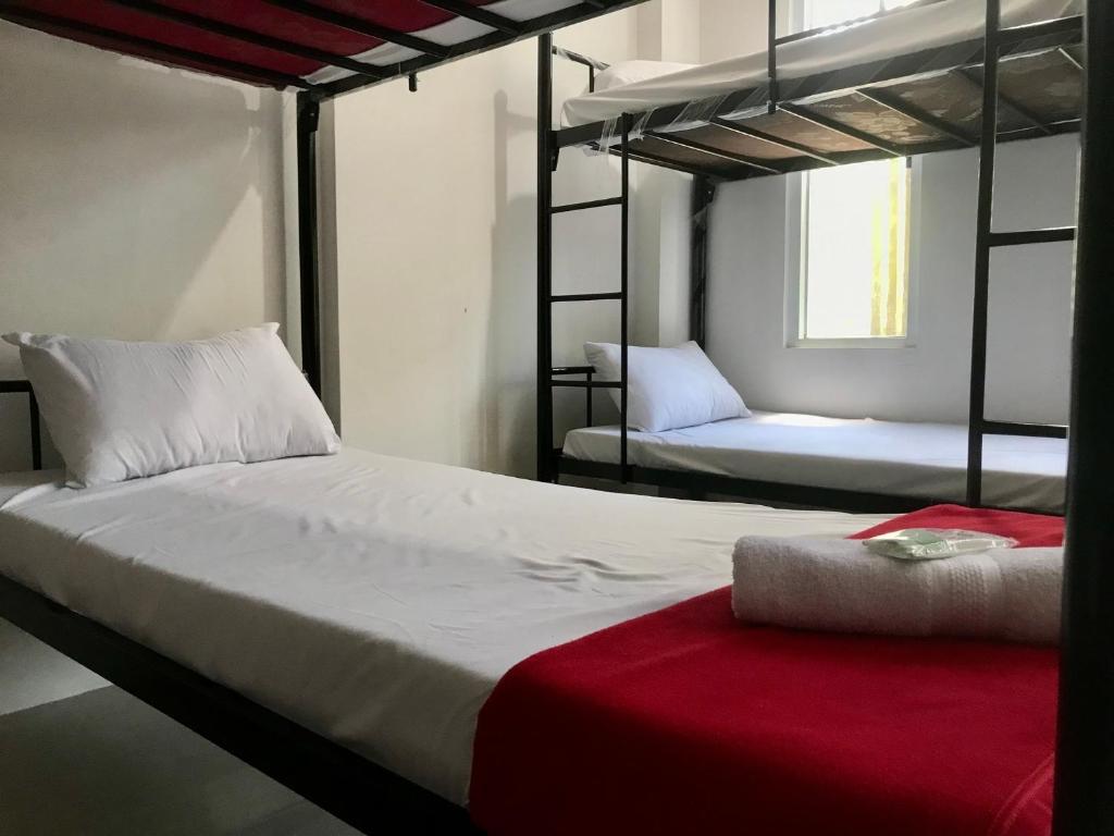 a bedroom with two bunk beds with a red blanket at Yayah Hostel in Bogor