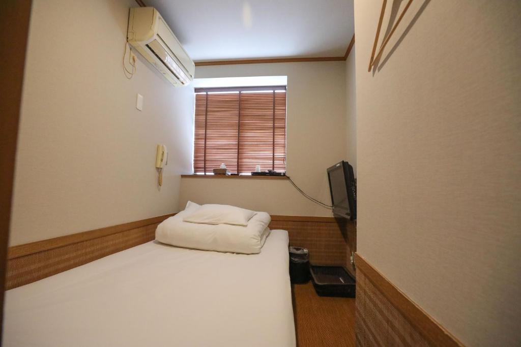 Postel nebo postele na pokoji v ubytování プチホテル　コスモス