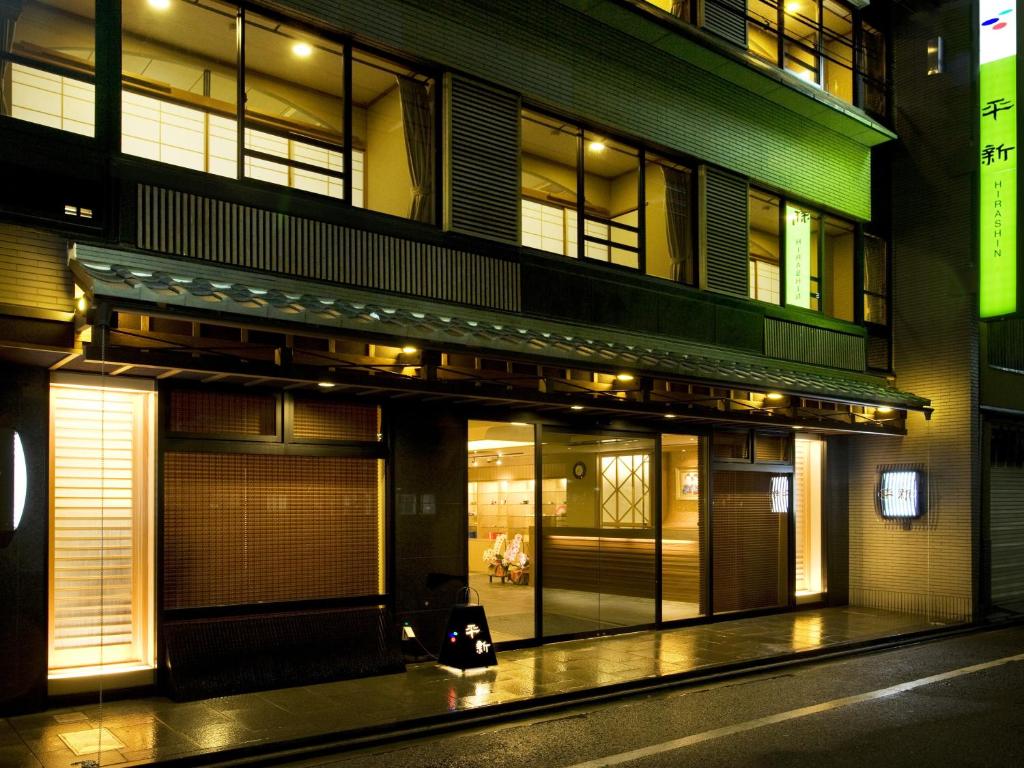 a building with a store front at night at Kyoto Ryokan Hirashin in Kyoto