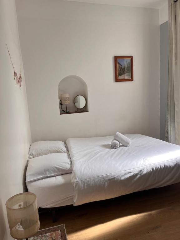 a bedroom with a bed and a mirror on the wall at Le jardin du roucas in Marseille