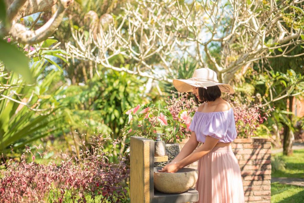 a woman in a hat is standing in a bowl at Cabé Bali in Jasri