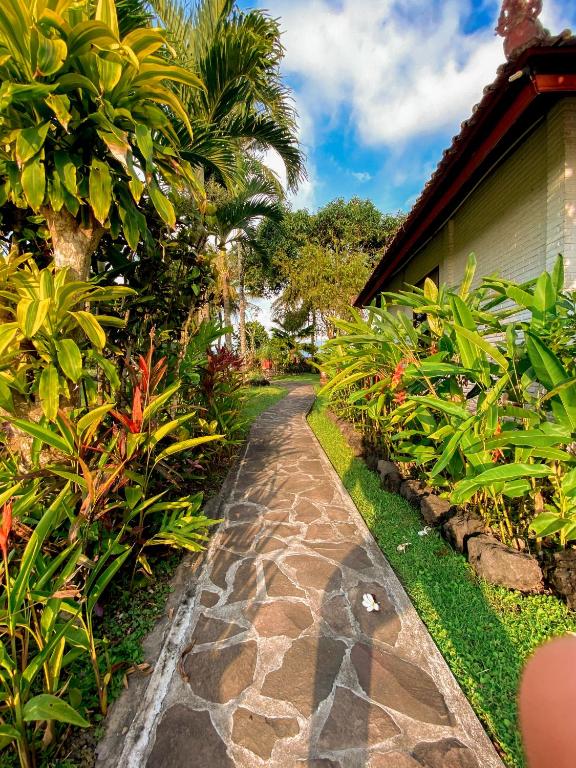 a garden path in front of a house at Cabé Bali in Jasri