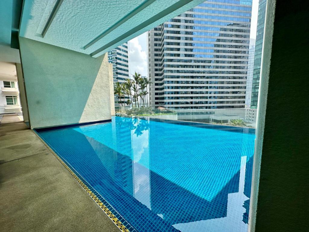 a swimming pool with a view of a building at Binjai 8 KLCC by PSM Luxury Suites in Kuala Lumpur