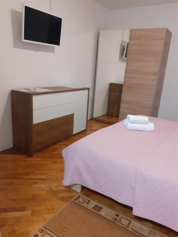 Postel nebo postele na pokoji v ubytování Apartments Novacic