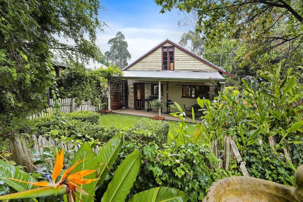 a small house in the middle of a garden at Blerick Country Retreat in Neerim South
