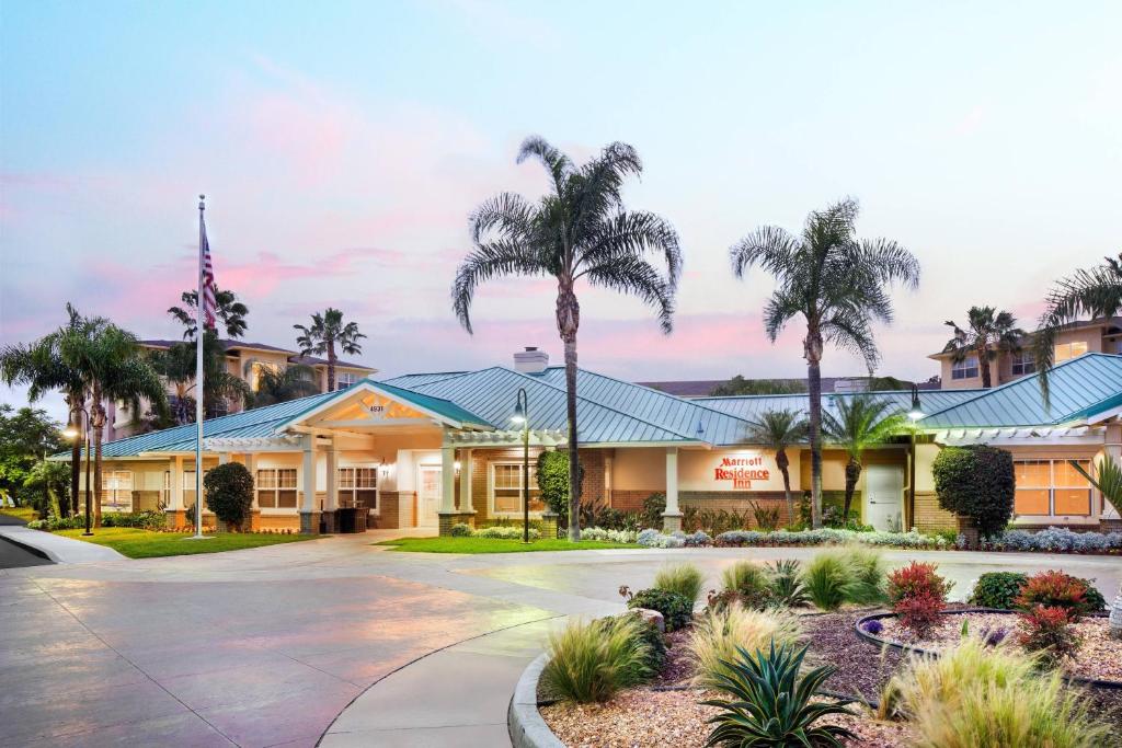 a hotel with palm trees in front of it at Residence Inn by Marriott Cypress Los Alamitos in Los Alamitos