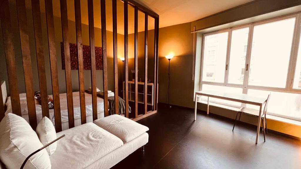 a living room with a couch and a table and a window at Lounge Apartment Orti in Udine