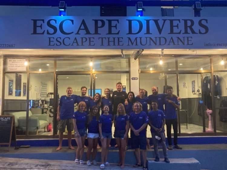 a group of people standing in front of a building at Escape Divers Hostel in Ko Tao