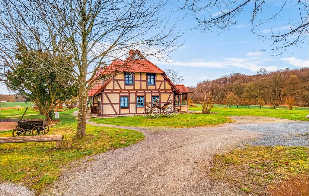 a house with a red roof on a dirt road at 1 Bedroom Awesome Apartment In Sehlen in Sehlen