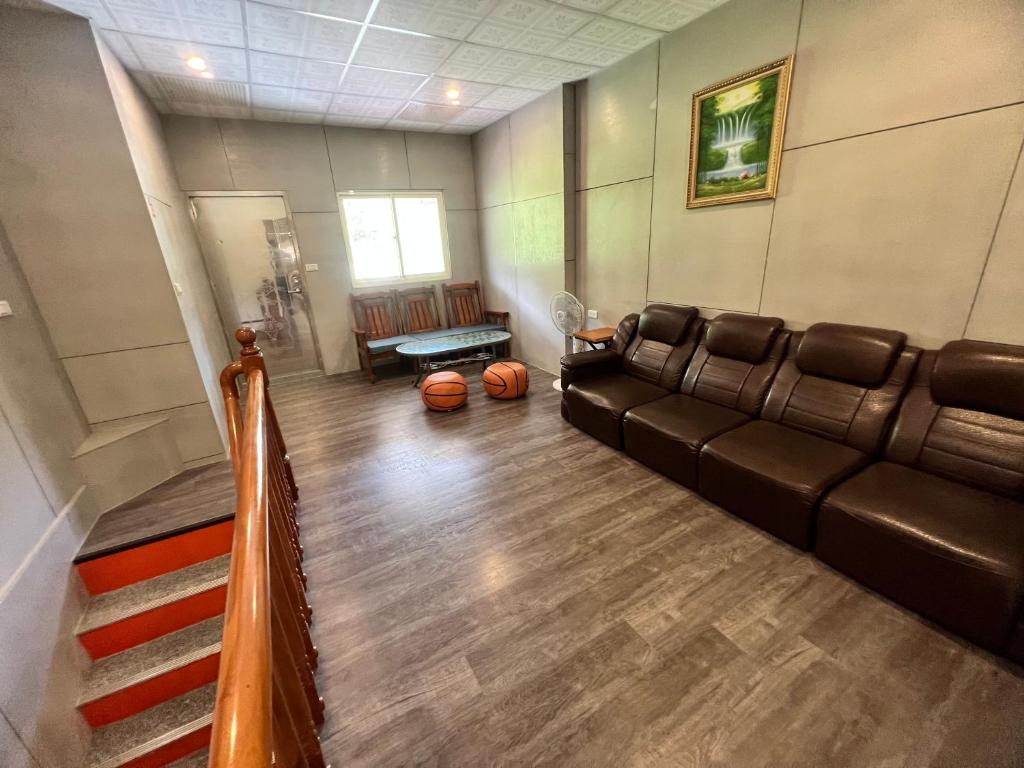 a living room with a couch and a table at Golden flower Homestay in Yuli