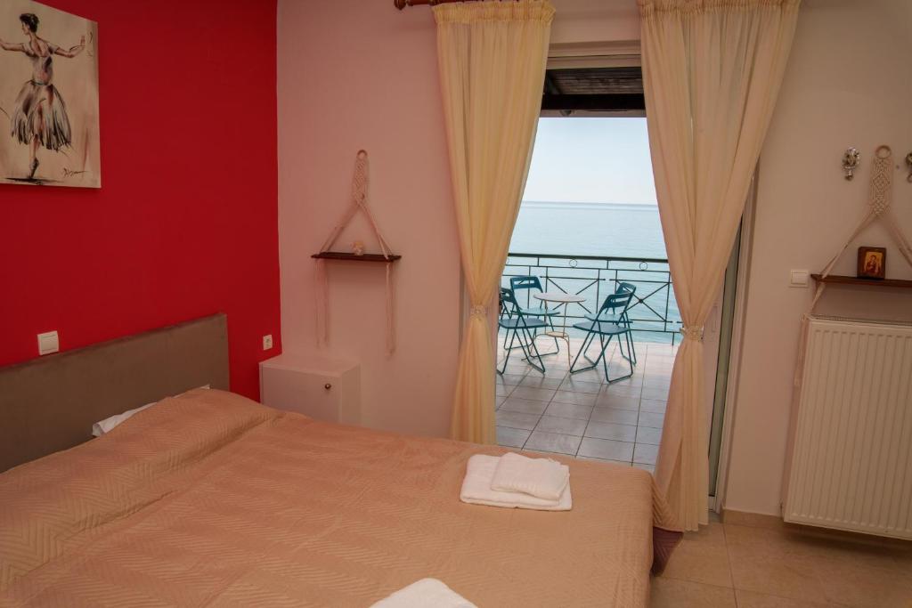 a bedroom with a bed and a view of the ocean at Golden Horizon Haven in Preveza