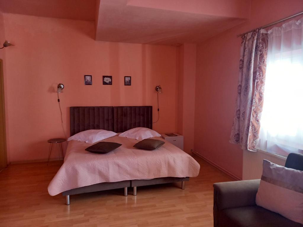 a bedroom with a bed with two pillows on it at Pensiunea Vila Dana in Cluj-Napoca