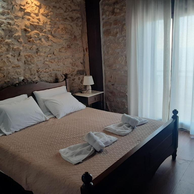 a bedroom with a bed with towels on it at Volakas Beachfront Suites in Rethymno