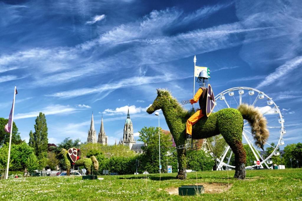 a statue of a woman riding a green horse in a park at Gîte de Blay in Blay