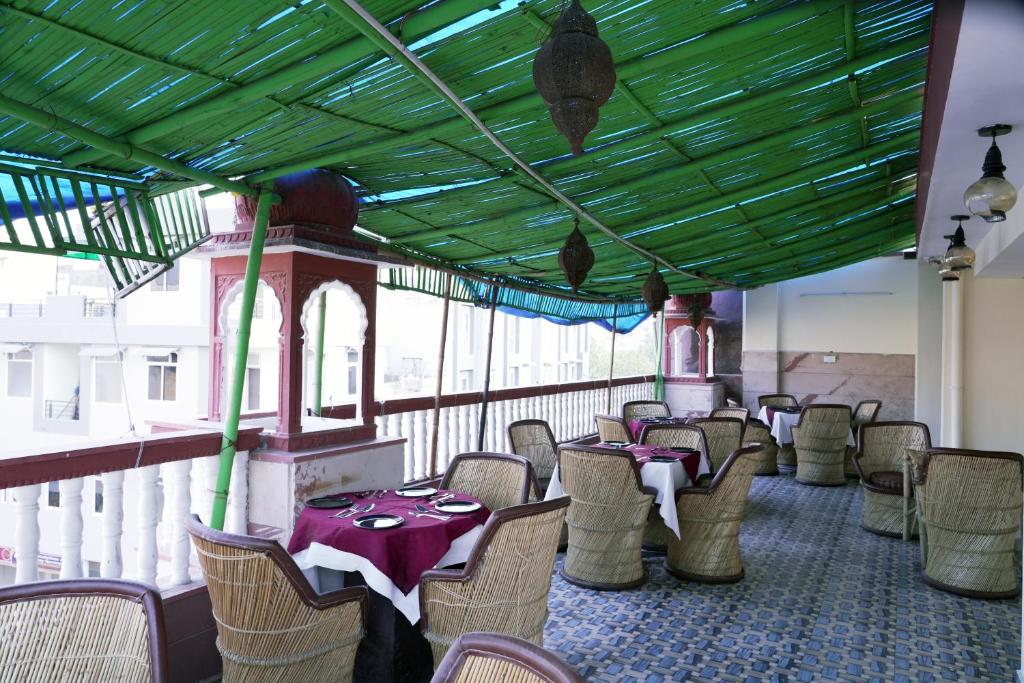 a dining room with tables and chairs on a train at Hotel Shree Narayan Palace in Jaipur
