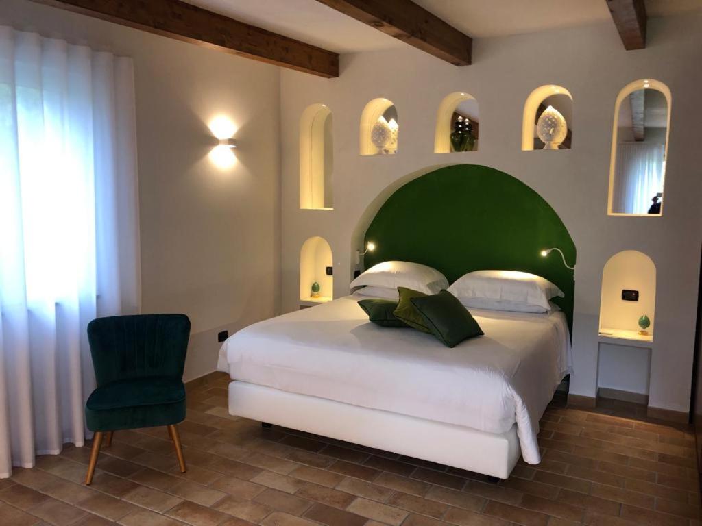 a bedroom with a large bed with a green headboard at Chalet Claudia in Sant'Agnello