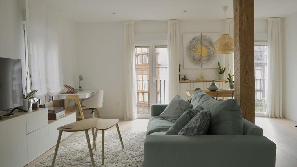 a living room with a couch and a table at MODERNO Y LUMINOSO EN EL CENTRO DE SANTANDER in Santander
