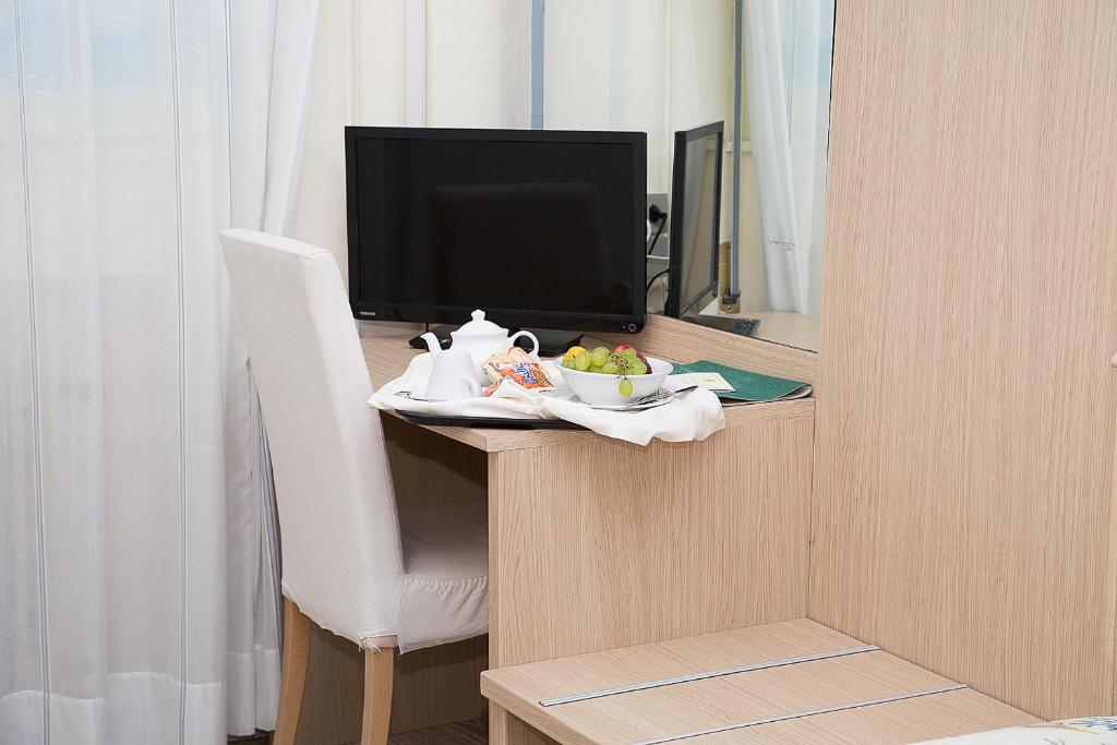 TV a/nebo společenská místnost v ubytování Hotel Umberto