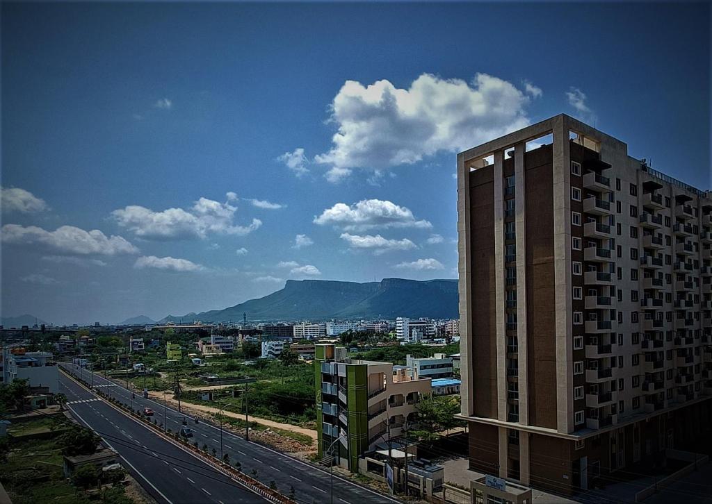 a view of a city with a tall building at Starlit Suites Tirupati LLP in Tirupati