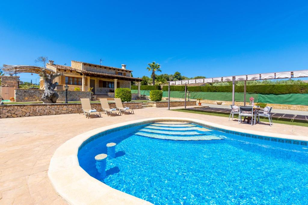 a swimming pool in front of a house at Ideal Property Mallorca - Sa Sinia in Lloret de Vistalegre