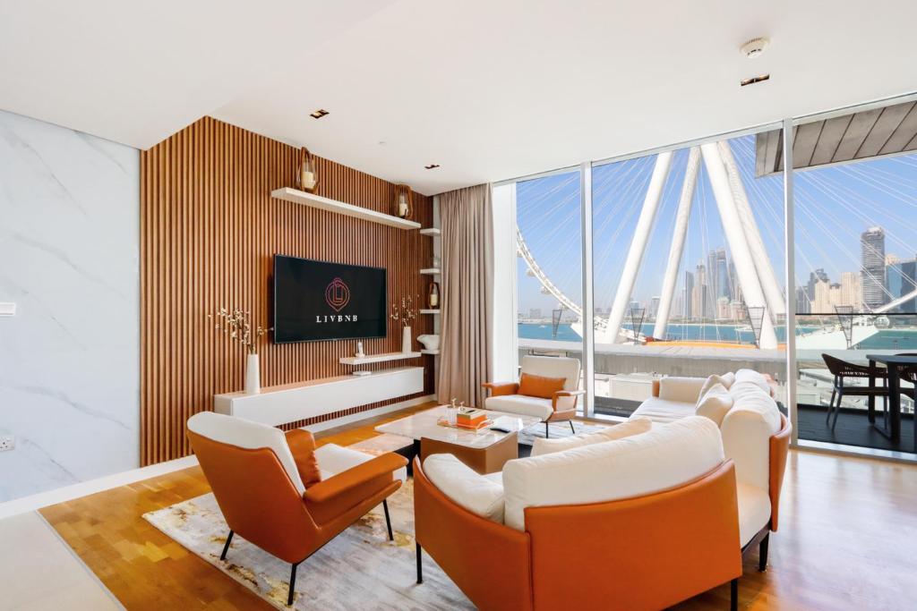 a living room with a view of the city at Livbnb - Alluring 3BR+1 w/Sea & Ain Dubai View in Dubai