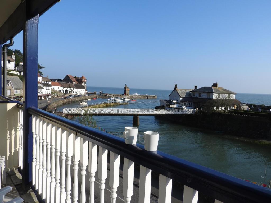 a balcony with a view of a body of water at Riverside Cottage B&B in Lynmouth