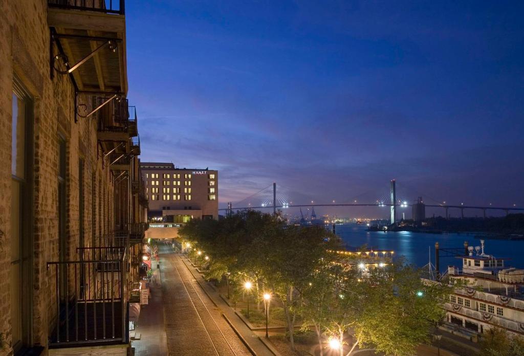 a city street at night with a bridge in the background at Hyatt Regency Savannah in Savannah