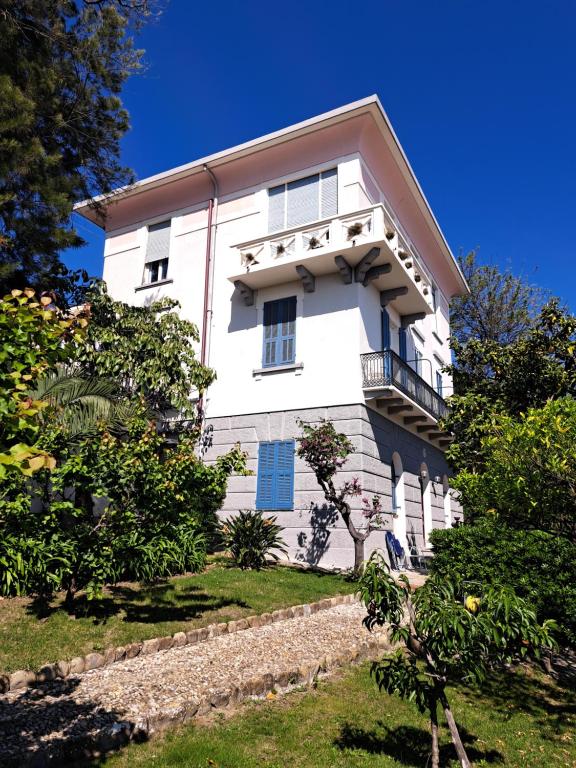 a white house with a balcony on a hill at Casa Gazzano in Imperia