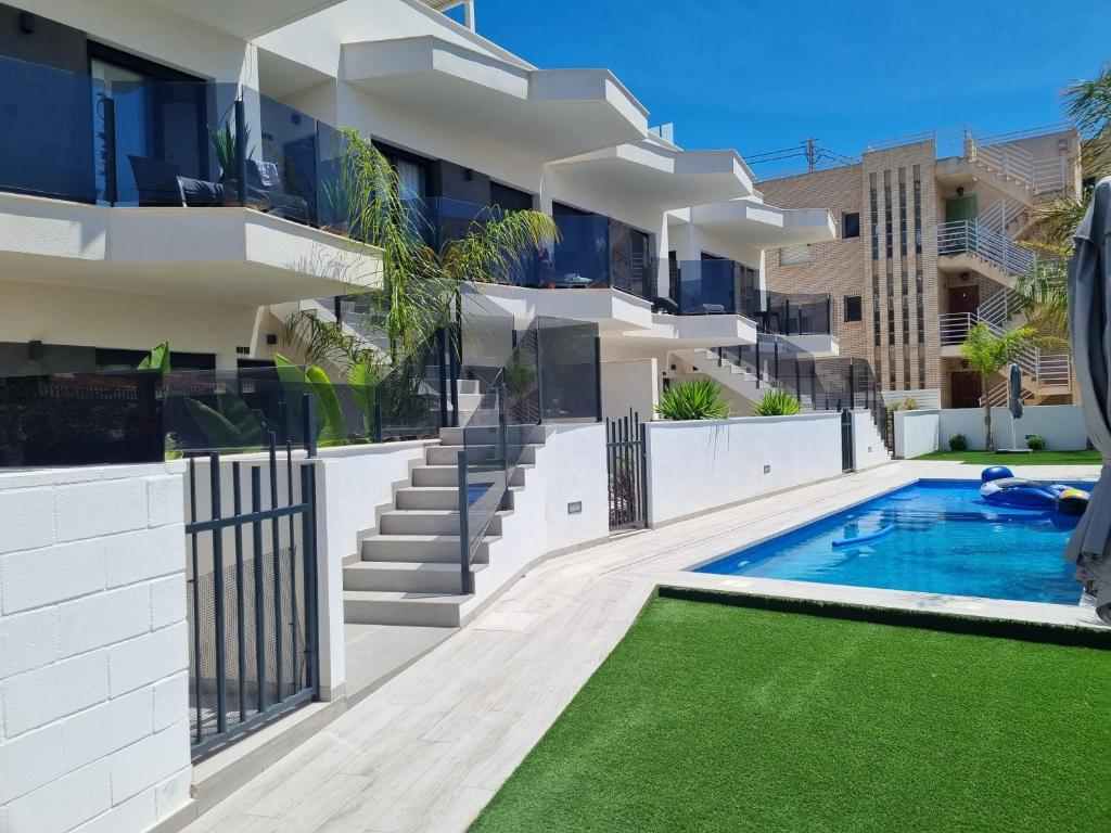 un edificio de apartamentos con piscina y patio en Luxe nieuwbouw appartement op 50m van de zee, en San Javier