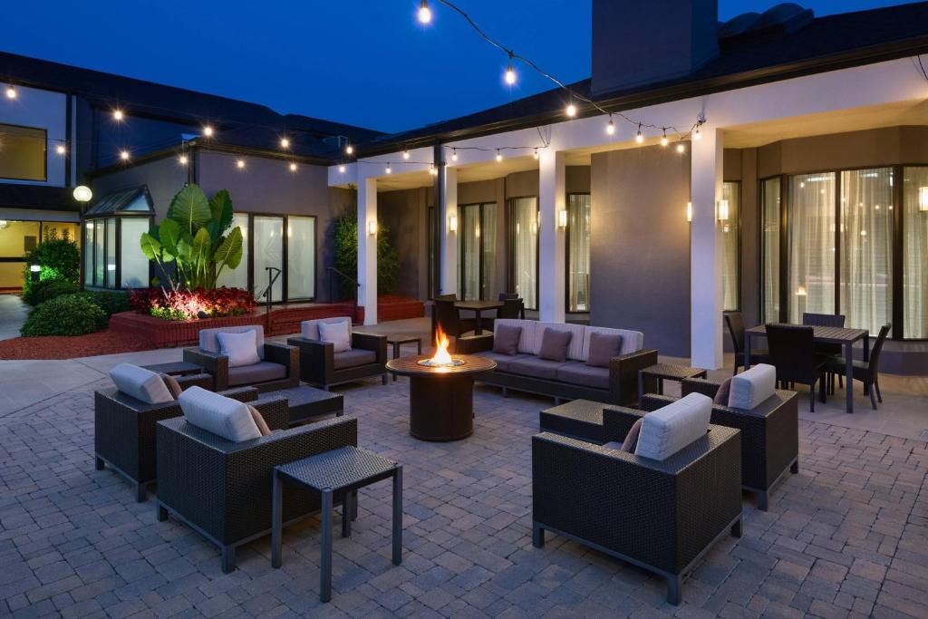 a patio with couches and chairs at night at Courtyard by Marriott Augusta in Augusta