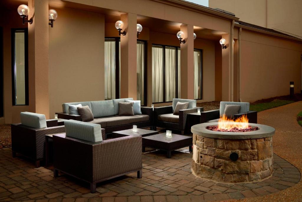 a patio with couches and a fire pit at Courtyard by Marriott Atlanta Airport South/Sullivan Road in Atlanta