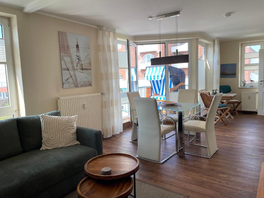 a living room with a couch and a table at Strandläufer in Cuxhaven