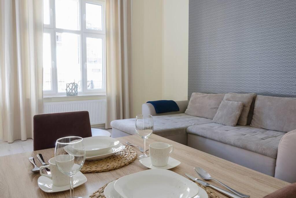 uma sala de estar com uma mesa e um sofá em Bryza - apartament w Sopocie by Grand Apartments em Sopot