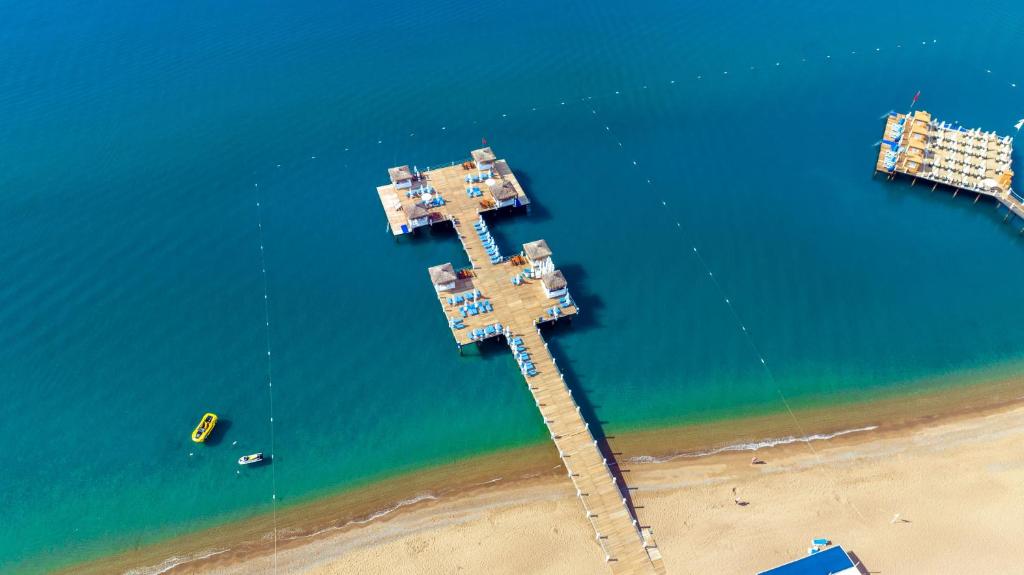 an overhead view of a pier in the water next to a beach at Liberty Hotels Lara in Lara