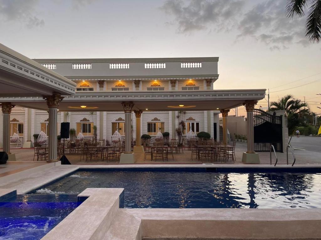 a house with a swimming pool in front of it at El Palacio Hotel & Resort in Cavite