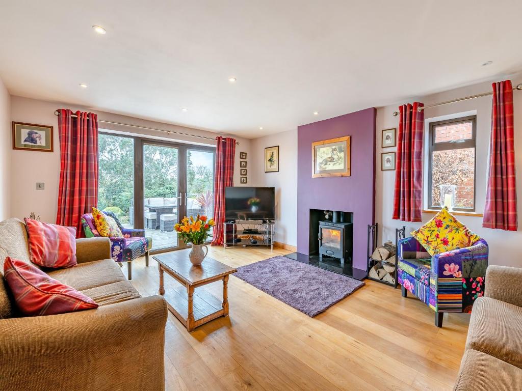 a living room with a couch and a fireplace at Highfields in Runswick