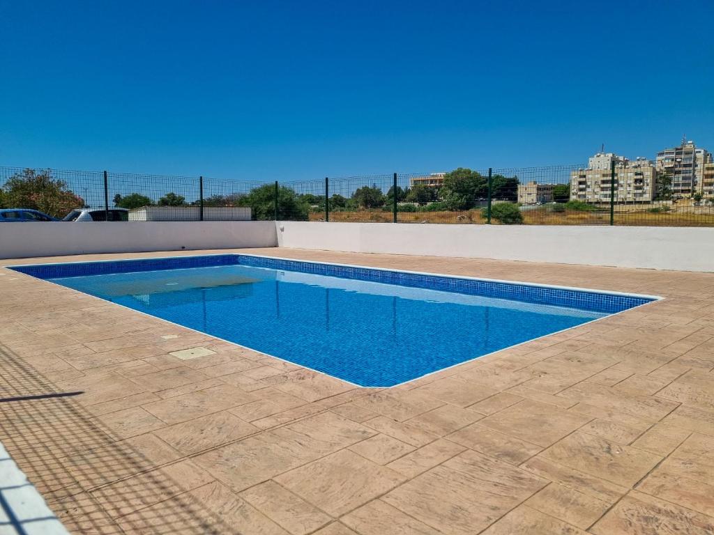 una piscina con acqua blu al centro di Dock Holiday Apartment a Larnaka