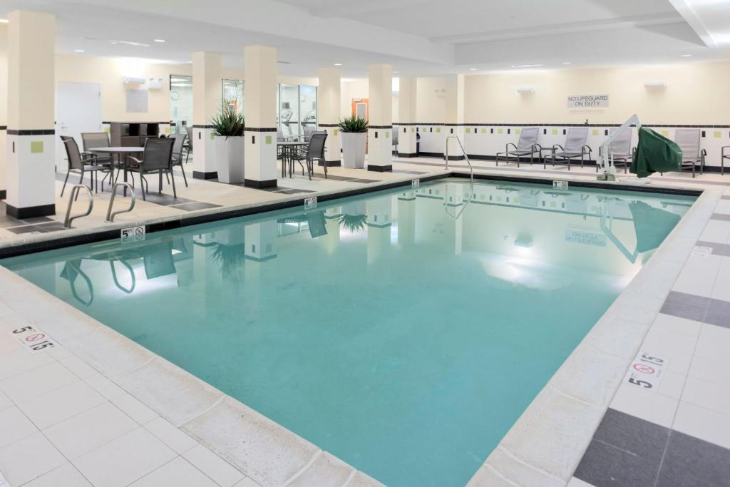 a large swimming pool with blue water in a building at Fairfield Inn & Suites by Marriott Wichita Downtown in Wichita