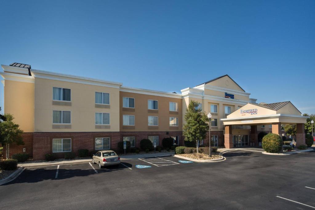 a hotel with a car parked in a parking lot at Fairfield Inn Hartsville in Hartsville