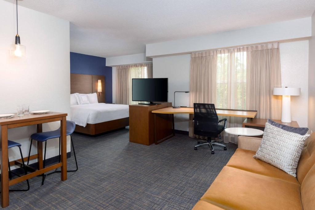 a hotel room with a bed and a desk at Residence Inn by Marriott Boston Brockton/Easton in Brockton